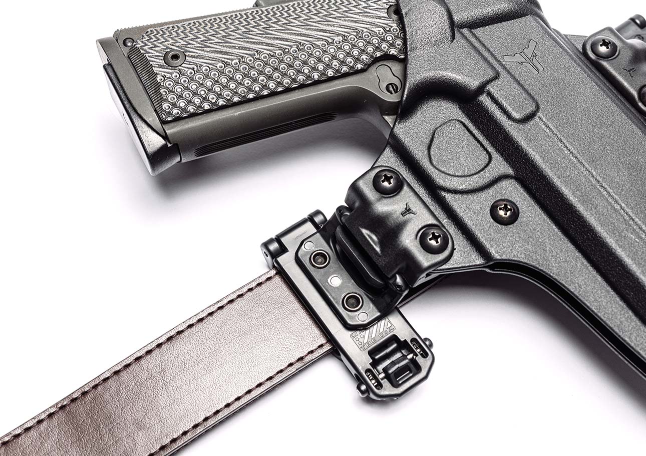 Close up of Toolless Modular Mod-Lok Attachment with Belt-Lok Mod on Total Eclipse 2.0 Gun Holster for Outside the Waistband Carry mounted onto Brown leather Ultimate Carry Gun Belt