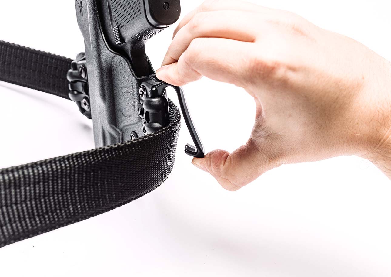 Person removing the IWB Mod on a Total Eclipse 2.0 Gun Holster from an Ultimate Carry Gun Belt