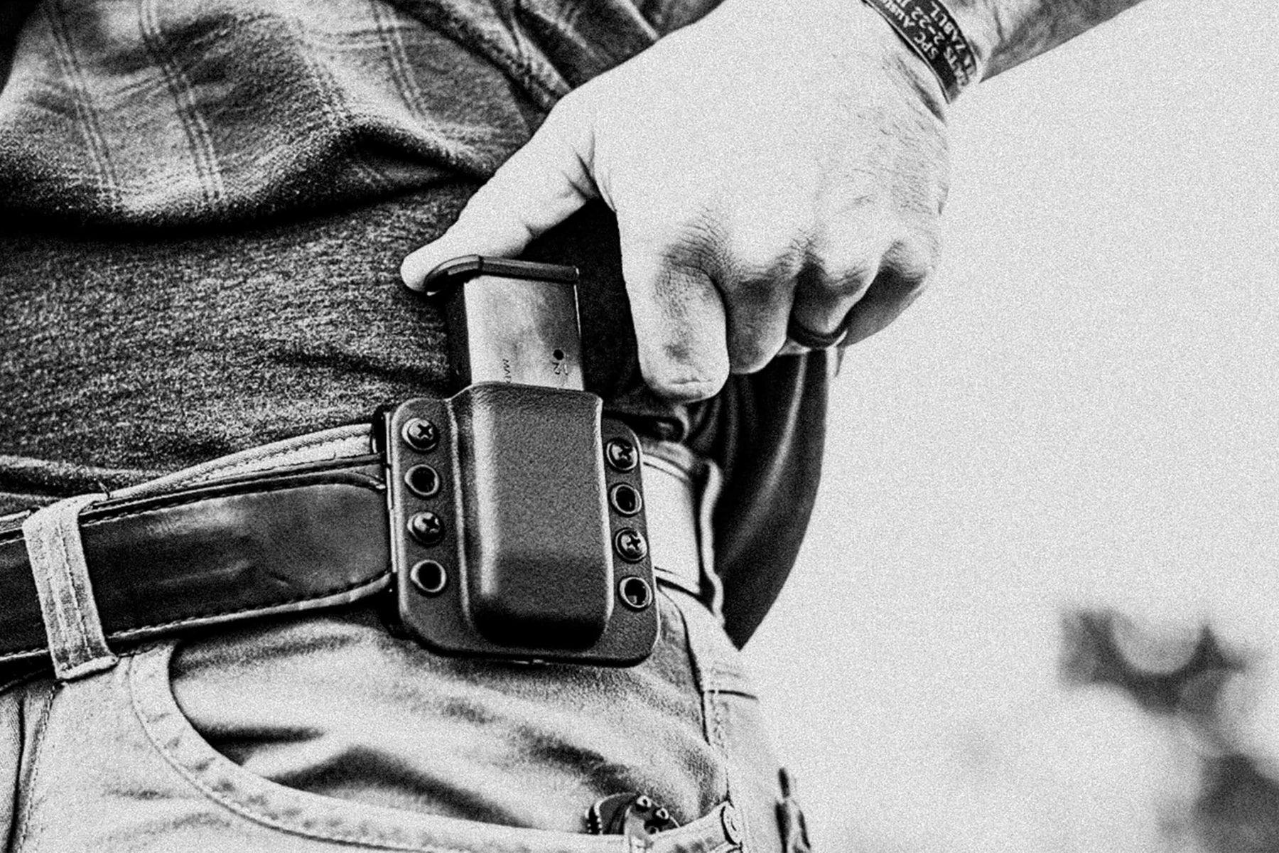 Person wearing Total Eclipse Single Mag Pouch Outside the Waistband / Inside the Waistband (OWB/IWB) on Black Leather Ultimate Carry Belt