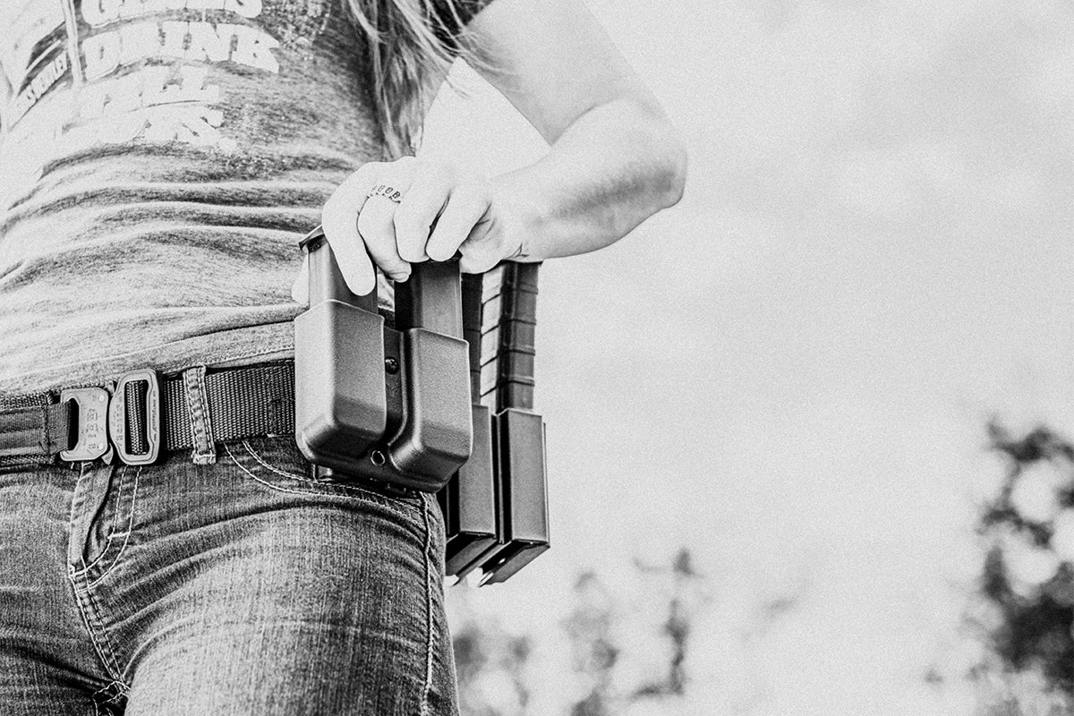 Person wearing Instructor's Gun Belt with AustriAlpin COBRA® Buckle and Signature Double Mag Pouch Outside the Waistband (OWB) Glock 9/40 and Signature AR Double Mag Pouch Outside the Waistband (OWB)