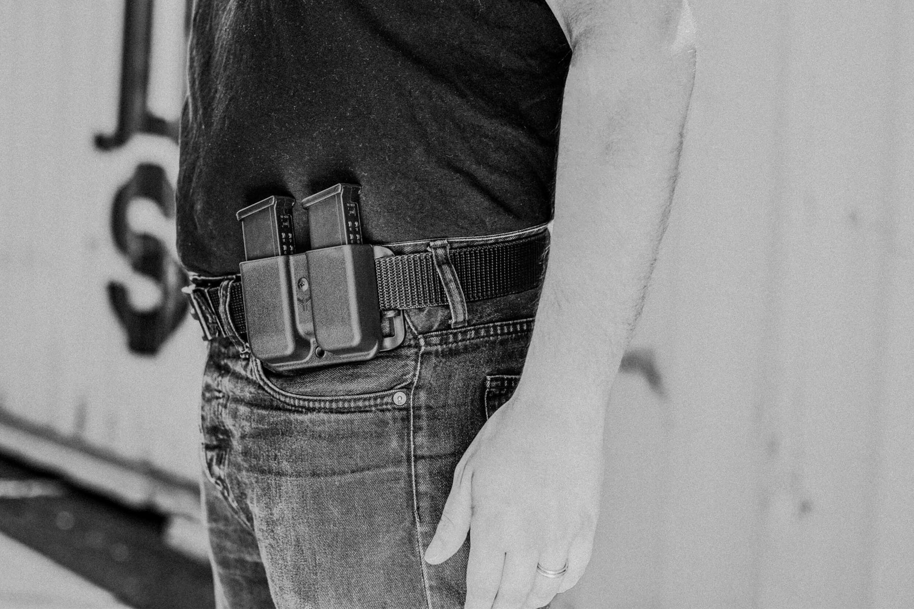 Person wearing Signature Double Mag Pouch including Adjustable Stingray Loop Belt Attachment with Glock 9/40 Handgun Magazines mounted onto Ultimate Carry Gun Belt with Ratcheting Belt Buckle