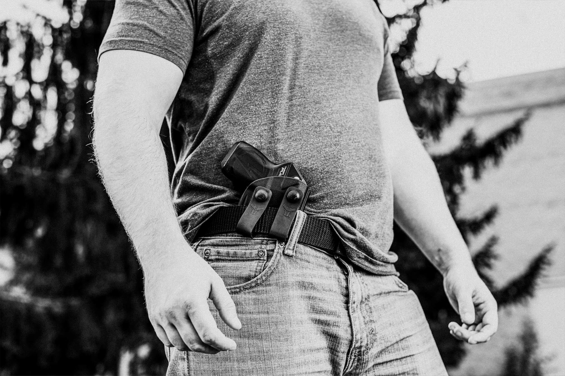 Person Wearing TASER Pulse Inside the Waistband (IWB) with IWB Loop Attachment mounted onto Ultimate Carry Gun Belt with Ratcheting Belt Buckle